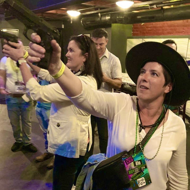Corporate Guests Playing Shooting Game On Music City Pub Crawl