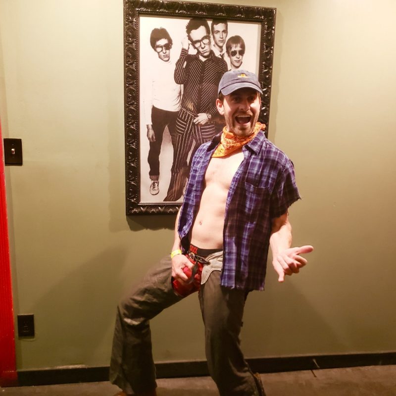 Bachelor Has No Shame Sporting Unbottoned Flannel, Chaps, And Boxer Briefs