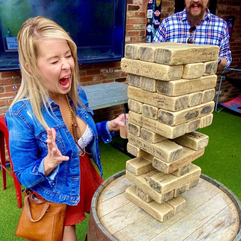 Tour Guest Engaged In A Thrilling Game Of Giant Jenga