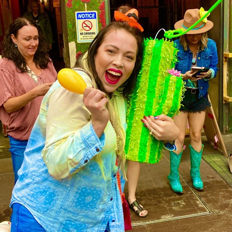 Tour Guest Holding Cactus Piñata One Last Time