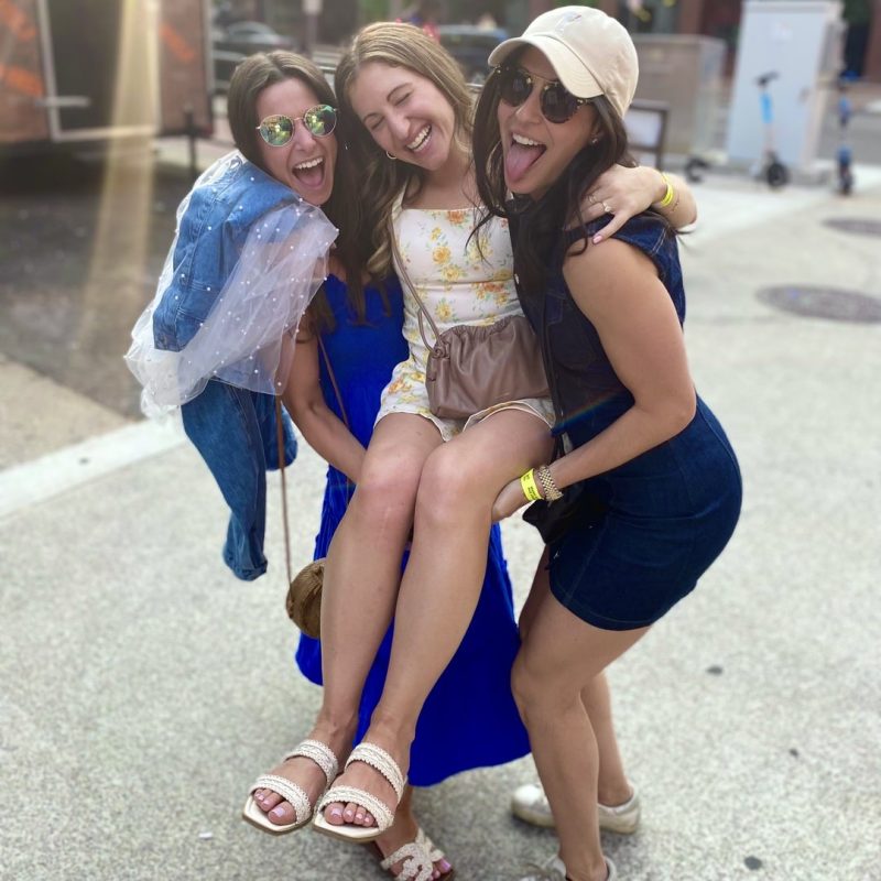 Two Friends Carrying The Bachelorette In Downtown Nashville