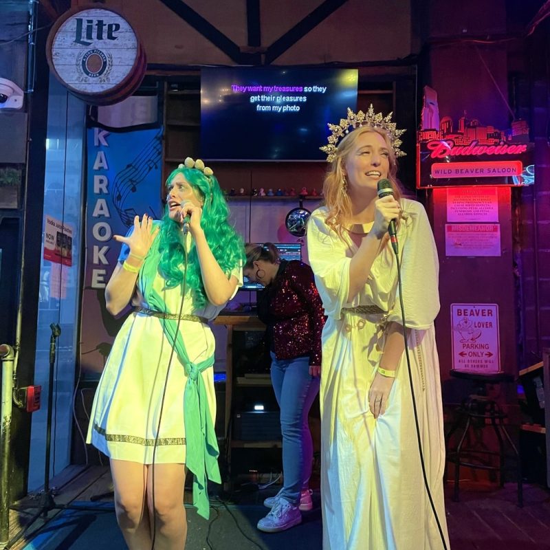 Tour Guests Dressed As Greek Goddesses While Singing Karaoke