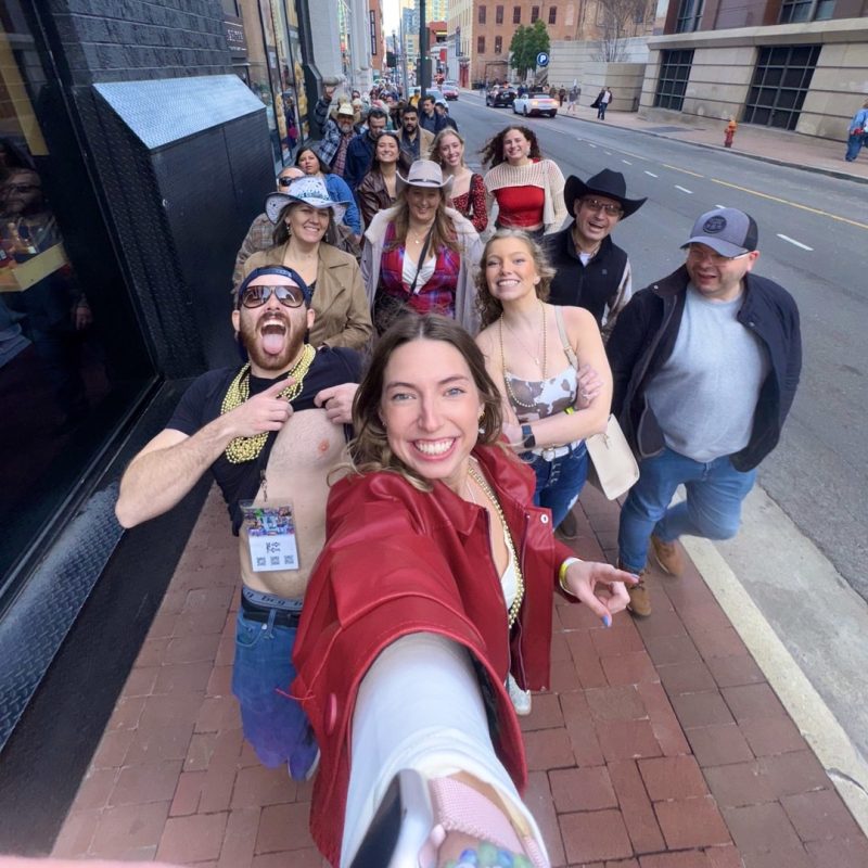 Guest Taking A Selfie With The Rest Of Her Tour Group